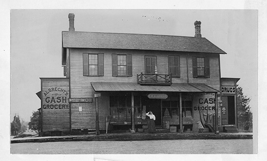 black and white historic photo of grocery storefront